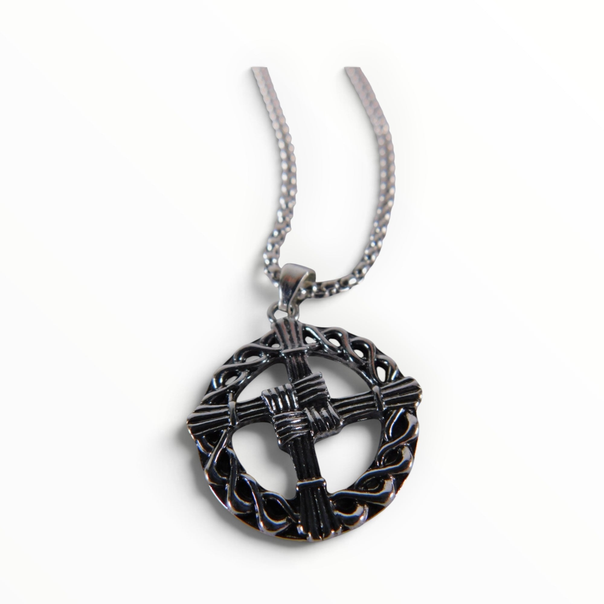The Witches' Quest silver tone St. Brigid’s Cross pendant necklace featuring a woven design inside a circular frame.