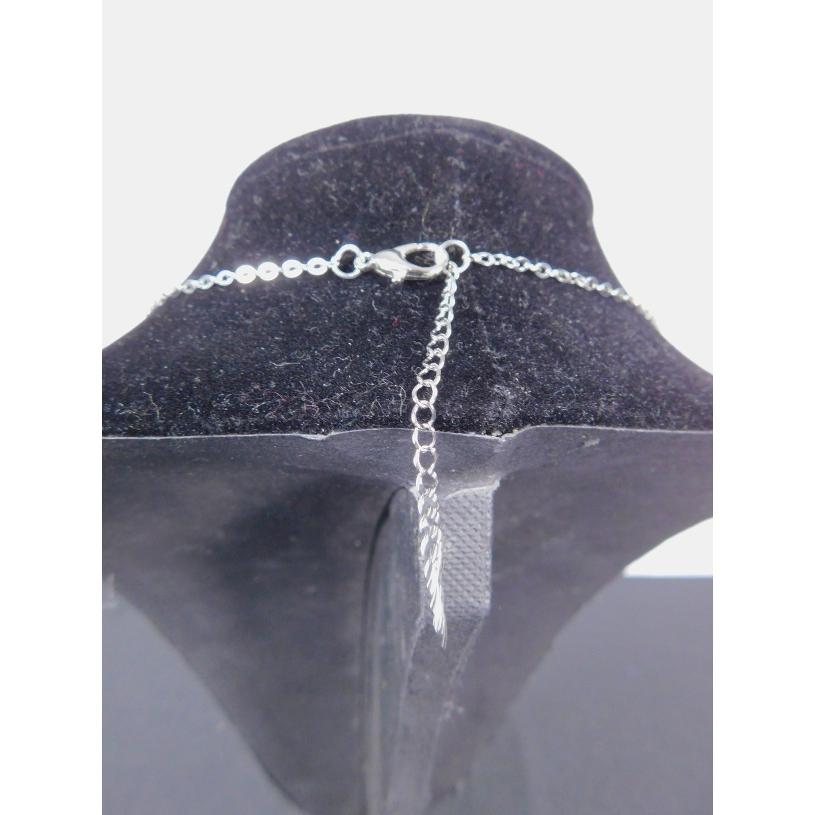 The Witches' Quest silver tone cable chain necklace with lobster claw clasp and extender on a black display bust