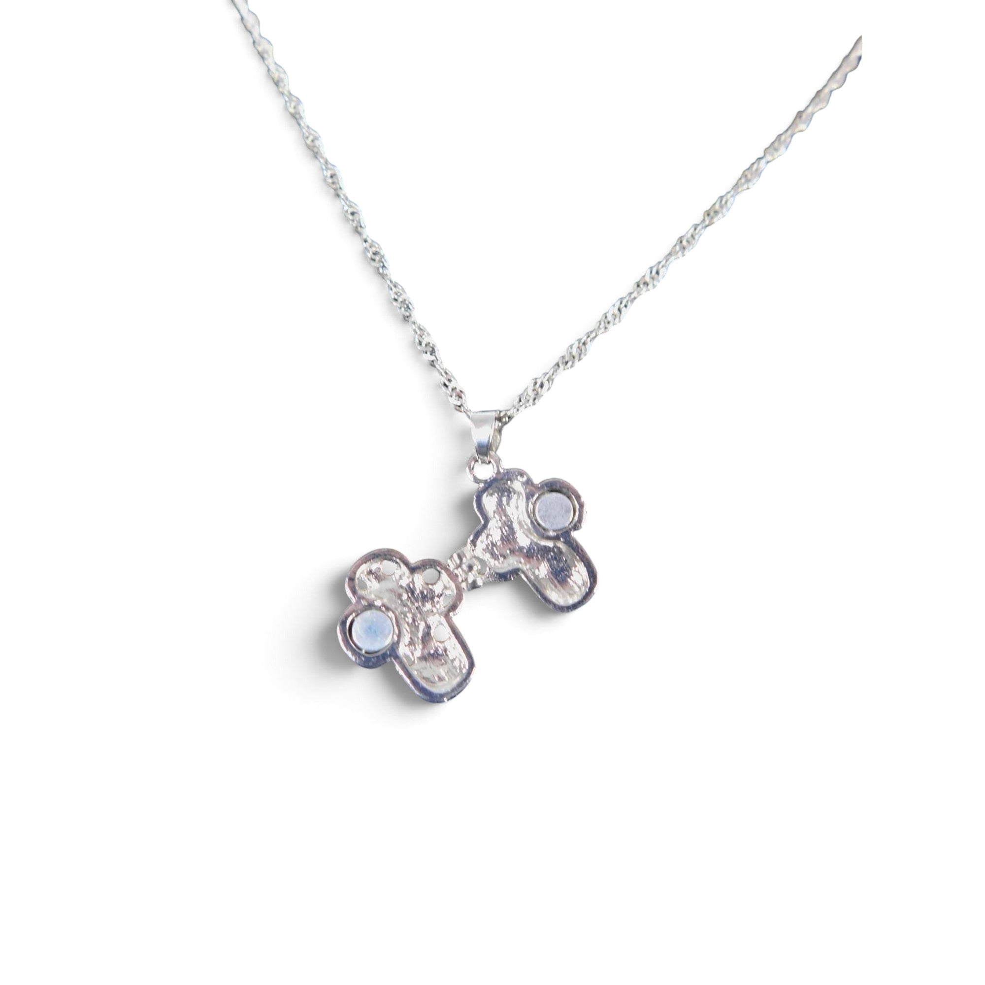 The Witches' Quest silver-tone alloy cross locket necklace with floral filigree and magnetic closure on an 18-inch chain