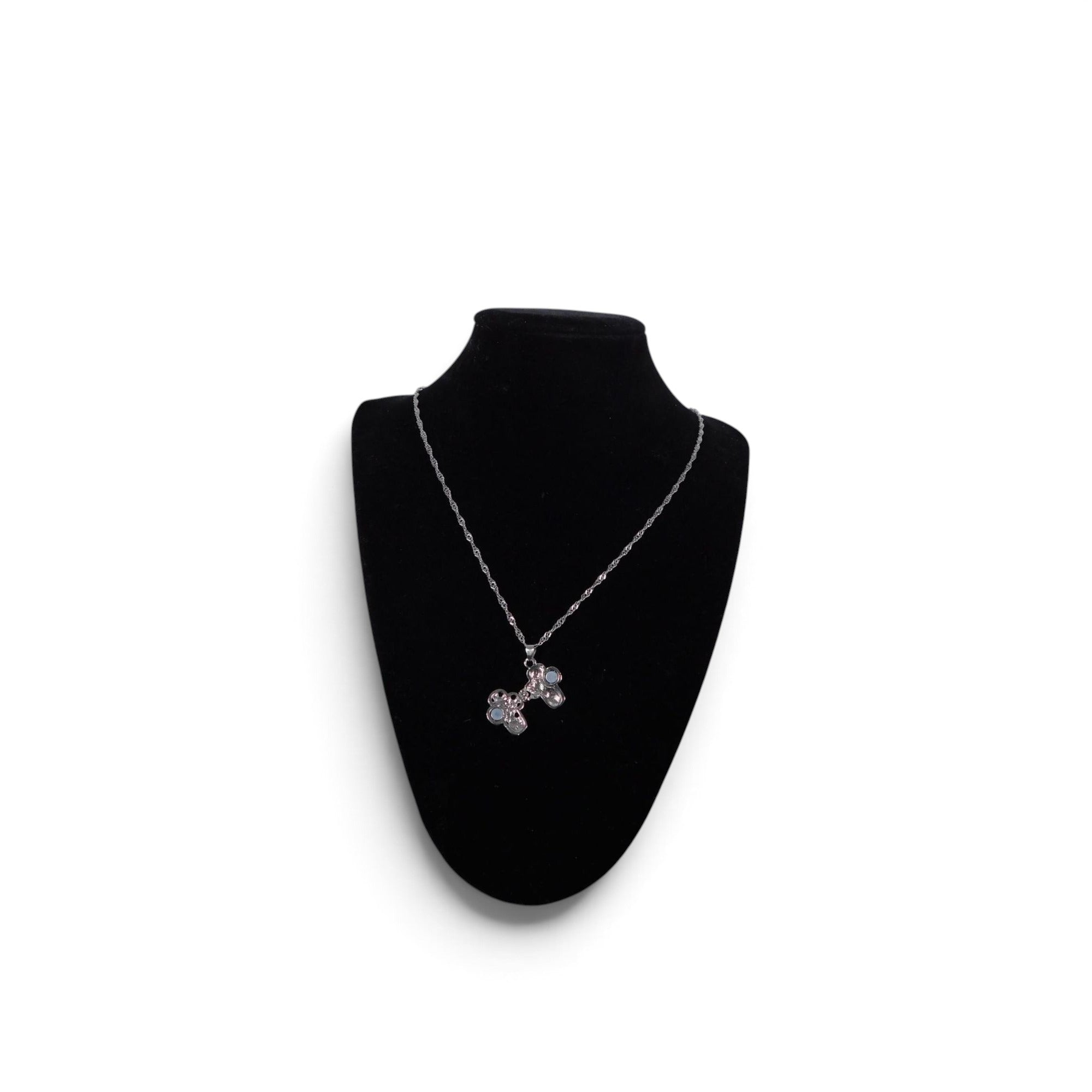 The Witches' Quest silver-tone alloy cross locket necklace with intricate floral filigree and magnetic closure.
