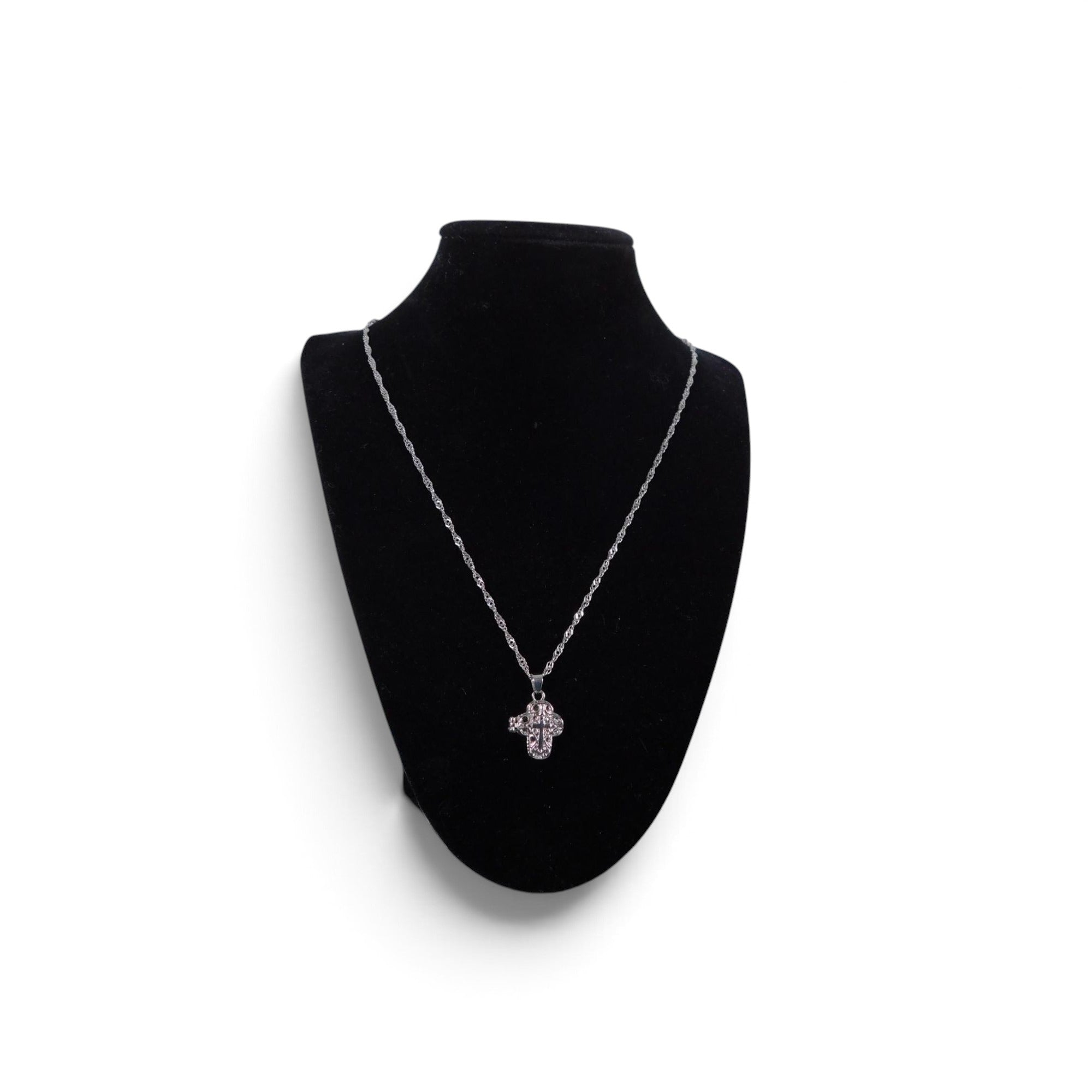 The Witches' Quest silver-tone alloy cross locket necklace with intricate floral filigree on a black display bust.