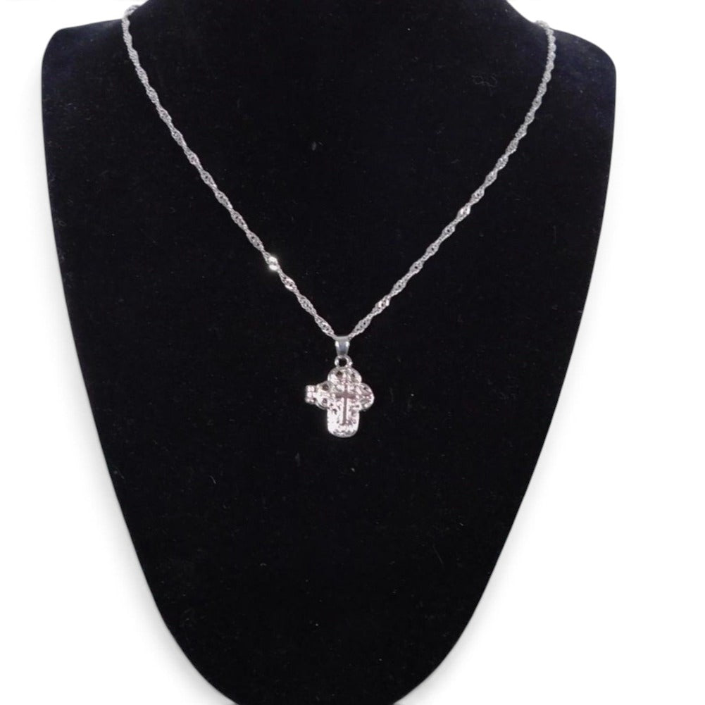 The Witches' Quest silver-tone cross locket necklace with intricate floral filigree and a magnetic secret compartment.