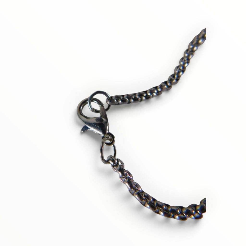 The Witches' Quest silver tone necklace featuring a durable link chain and a secure lobster claw clasp closure.