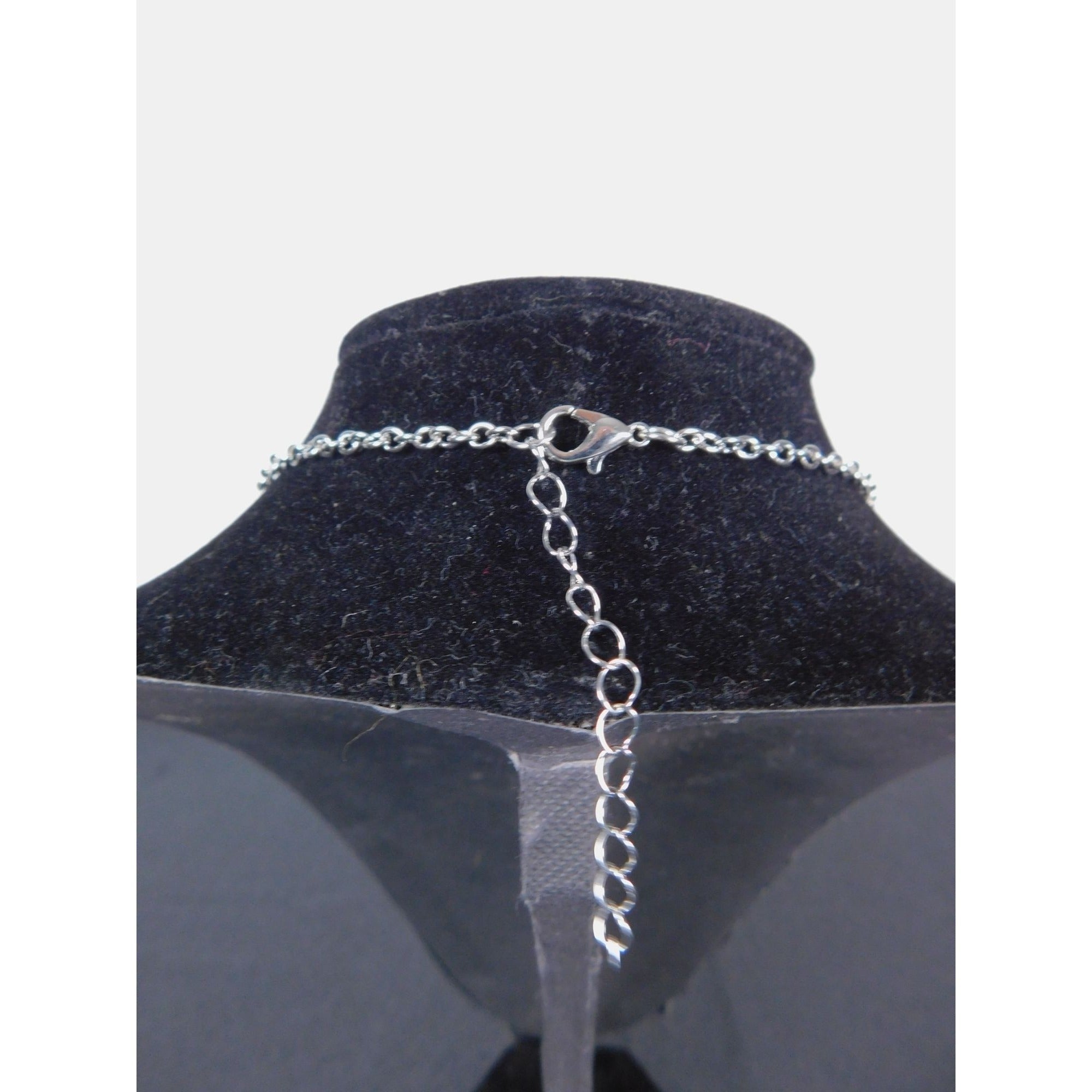 The Witches' Quest silver-tone necklace chain with lobster clasp and adjustable extender on a black display bust
