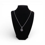 The Witches' Quest silver tone Victorian poison box locket necklace with textured wings on a black display bust