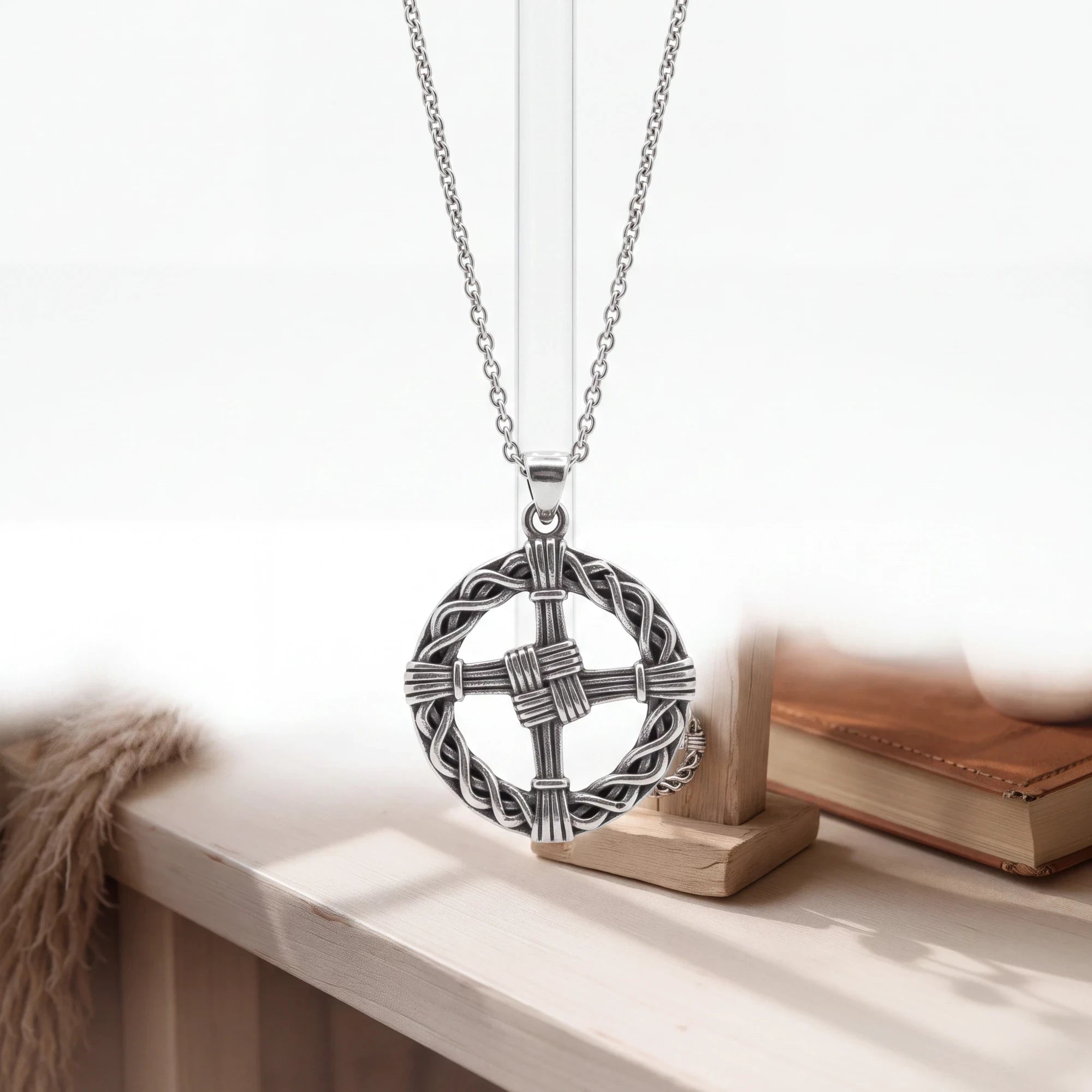 The Witches' Quest silver tone St. Brigid’s Cross pendant featuring an intricate woven design on a matching link chain.