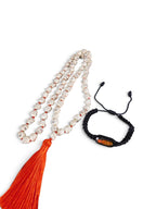 The Witches' Quest howlite skull prayer beads with orange tassel and black Santa Muerte bracelet on white background