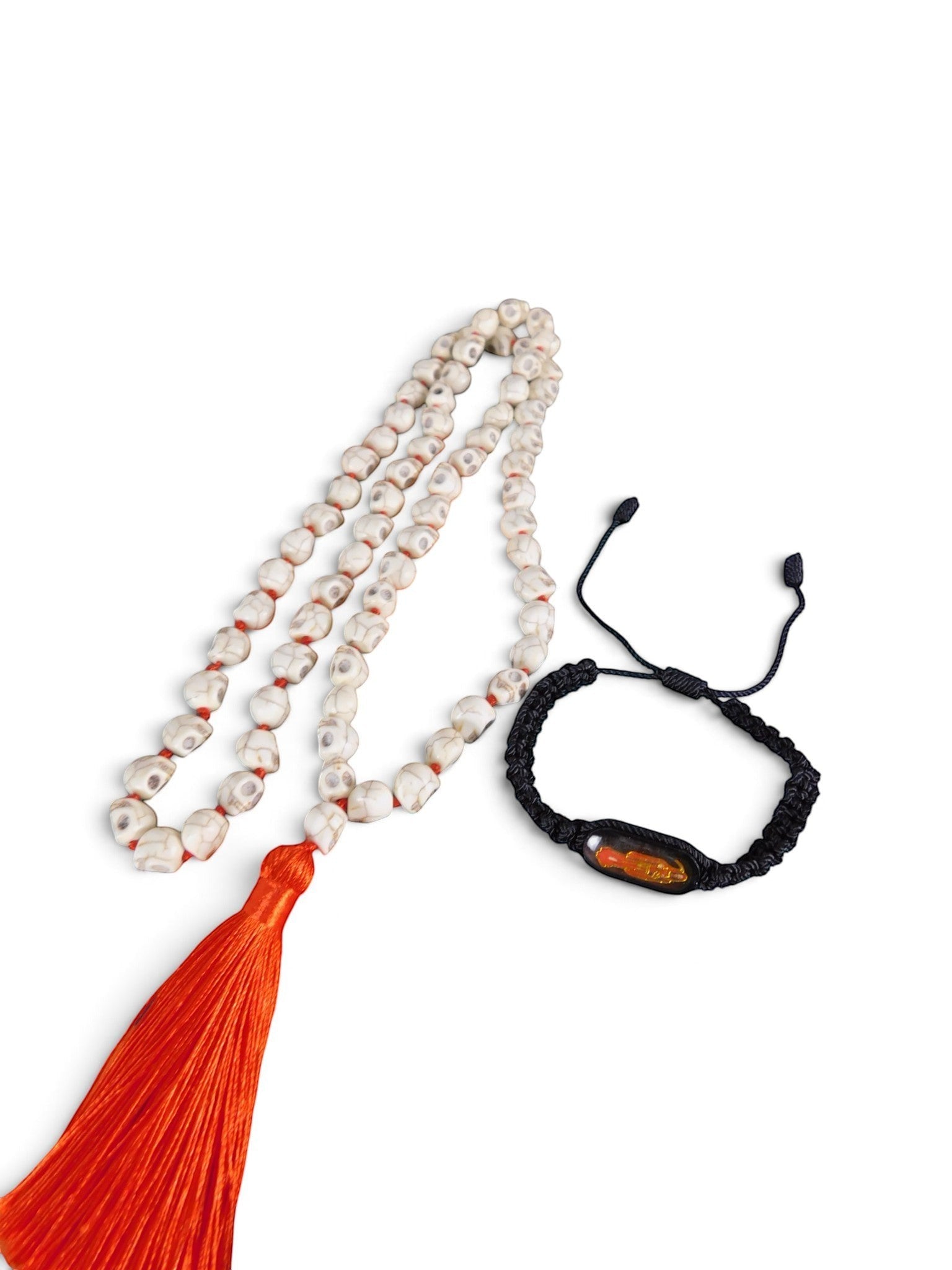The Witches' Quest howlite skull prayer beads with orange tassel and black Santa Muerte bracelet on white background