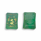 The Witches' Quest Practical Witch's Spell Deck cards featuring green botanical illustrations and gold text.