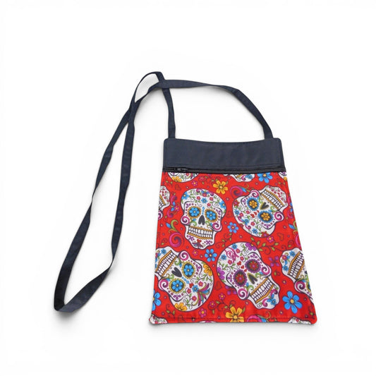 The Witches' Quest handcrafted crossbody bag with a vibrant red sugar skull pattern and adjustable shoulder strap.