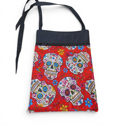 The Witches' Quest handcrafted crossbody bag featuring a vibrant red sugar skull pattern and adjustable black strap.