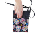 The Witches' Quest handcrafted sugar skull crossbody bag with vibrant floral skull print and adjustable strap.