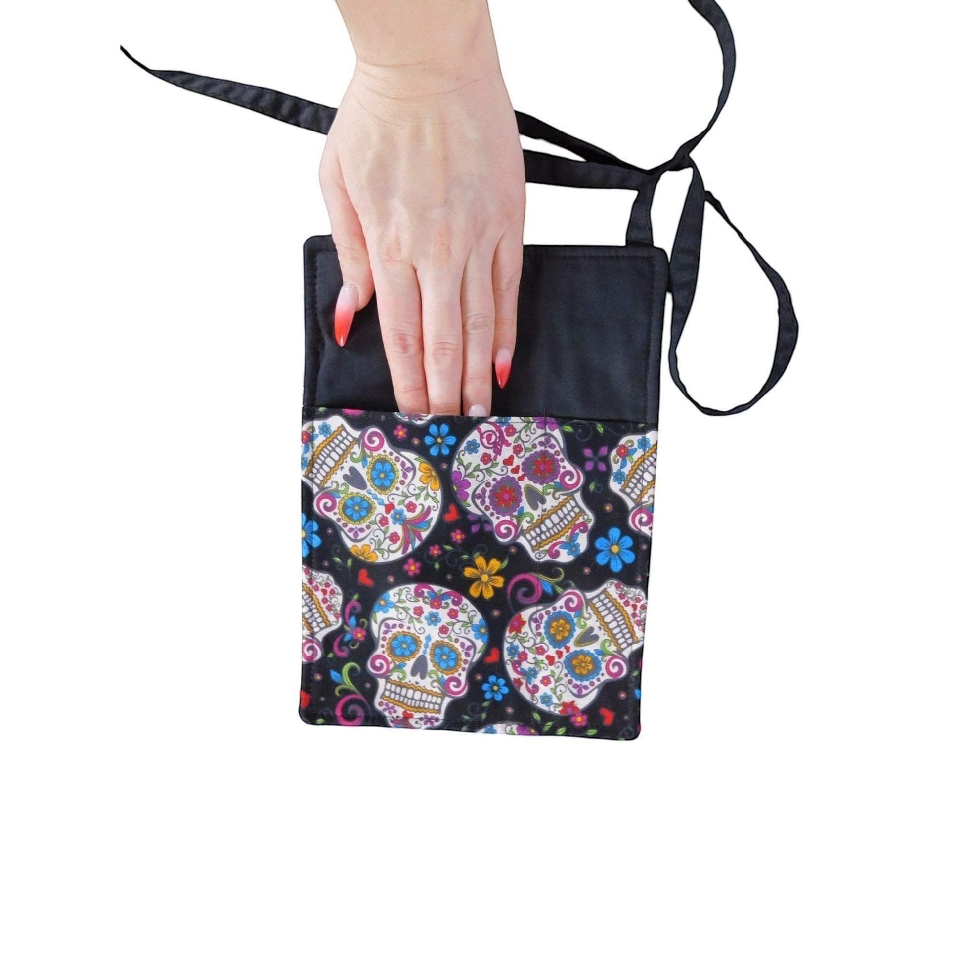 The Witches' Quest handcrafted sugar skull crossbody bag with vibrant floral skull print and adjustable strap.
