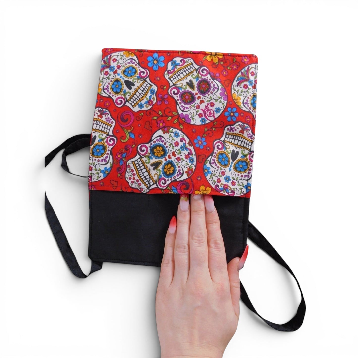 The Witches' Quest handcrafted crossbody bag with a vibrant red sugar skull pattern and black bottom panel