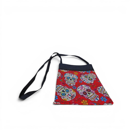 The Witches' Quest handcrafted crossbody bag with a vibrant red sugar skull pattern and adjustable shoulder strap.