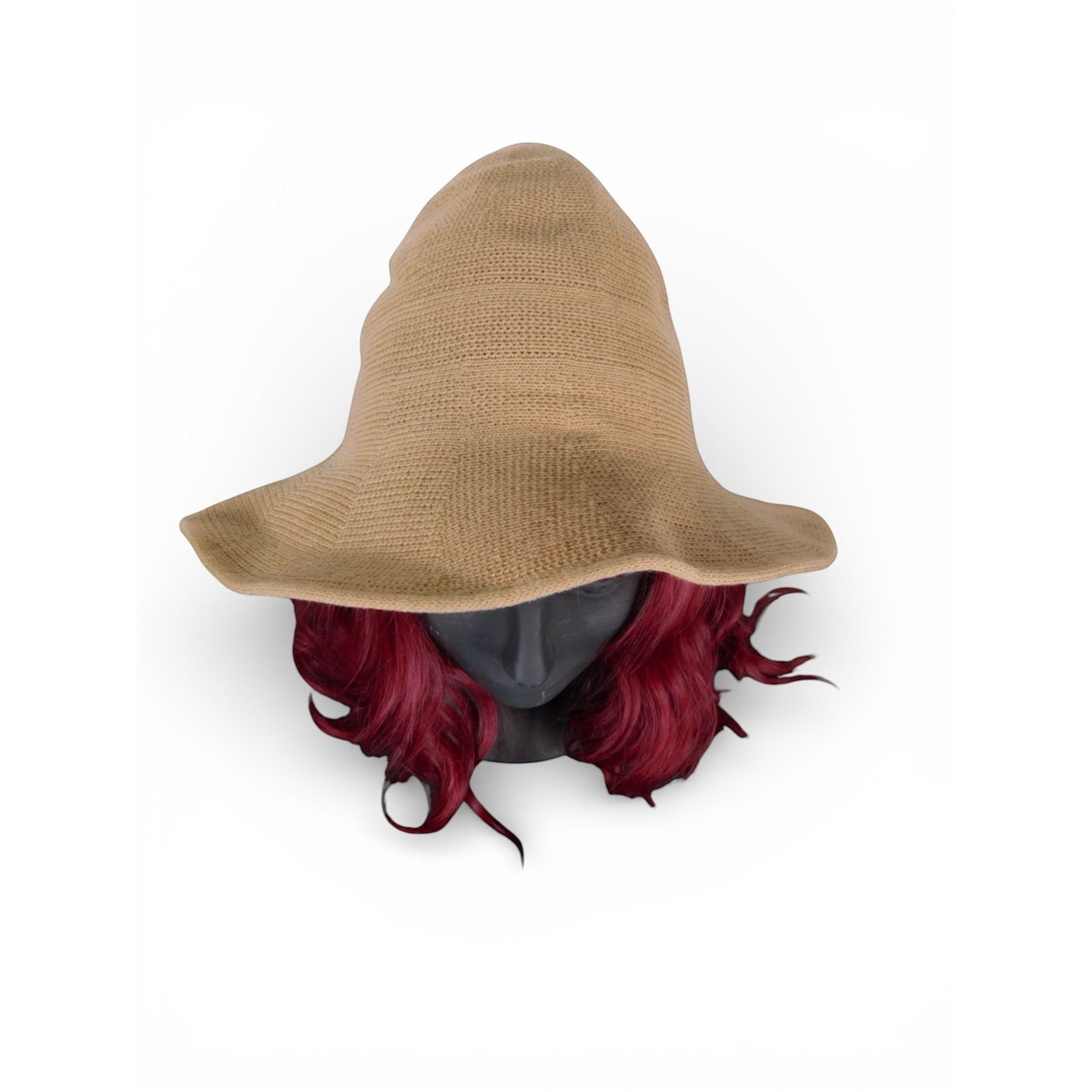 The Witches' Quest tan knit pointed brim hat on a mannequin head with vibrant red hair