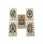 The Witches' Quest Tattoo Tarot mini deck featuring vintage tattoo-style illustrations of swords and roses on cards.