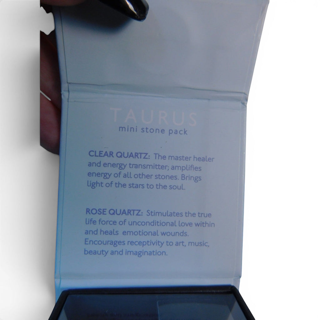 The Witches' Quest Taurus zodiac crystal pack box featuring clear and rose quartz descriptions