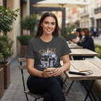 Woman wearing The Witches' Quest charcoal grey crew neck t-shirt with The Craft movie graphic print at an outdoor cafe.