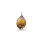The Witches' Quest teardrop Tiger's Eye pendant with intricate wire-wrapped Tree of Life design in golden-brown tones.