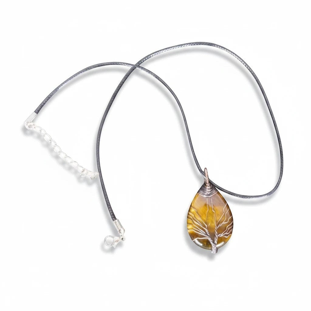 The Witches' Quest Tiger's Eye teardrop pendant with wire-wrapped Tree of Life design on a black cord necklace.