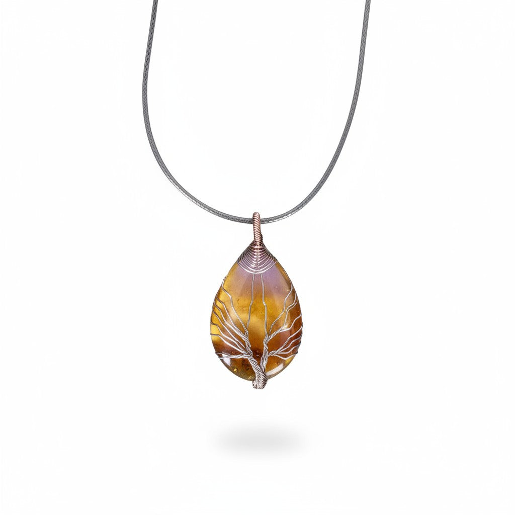 The Witches' Quest teardrop Tiger's Eye pendant with silver wire-wrapped Tree of Life design on a black cord necklace.