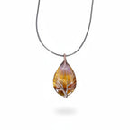 The Witches' Quest teardrop Tiger's Eye pendant with silver wire-wrapped Tree of Life design on a black cord necklace.