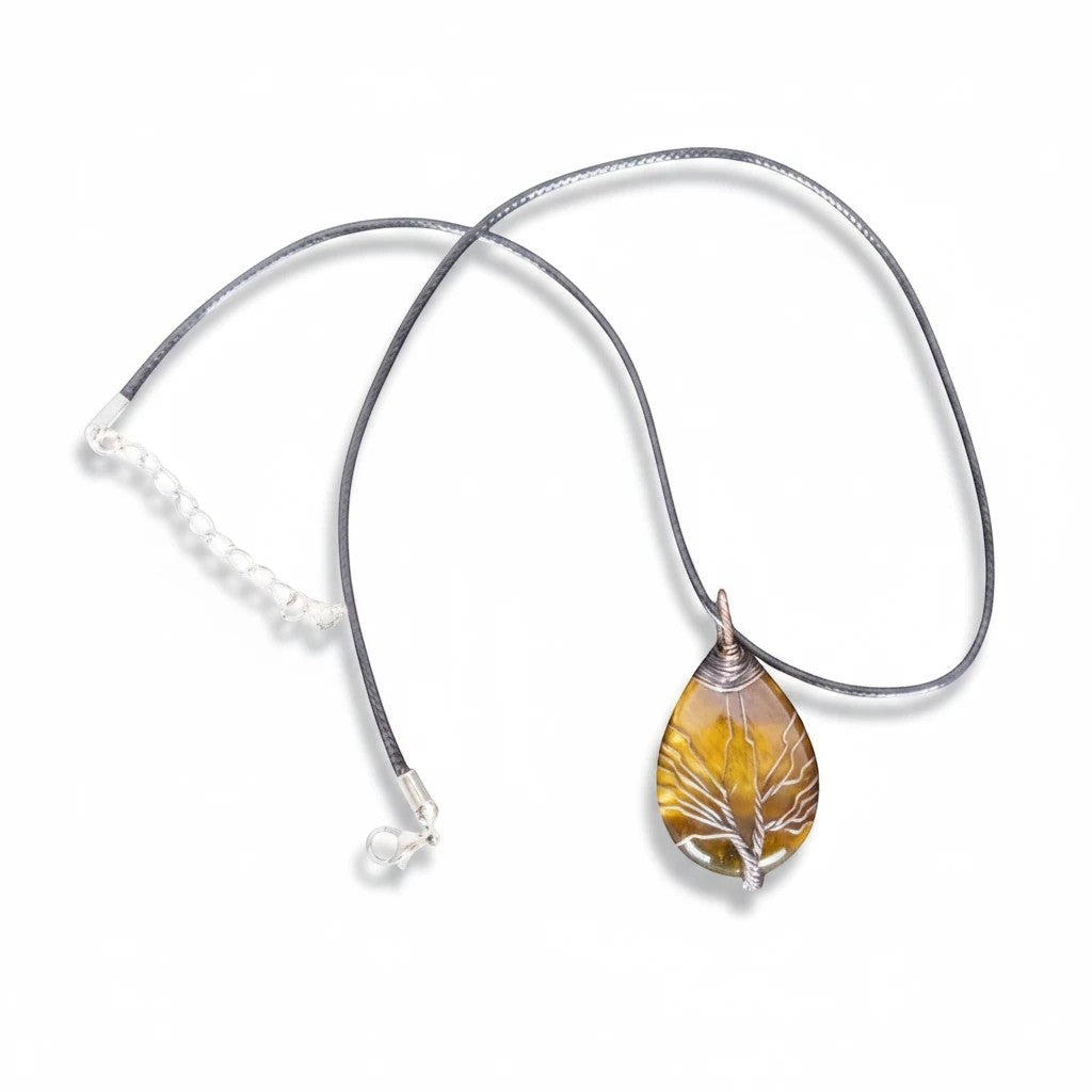 The Witches' Quest Tiger's Eye teardrop pendant with a wire-wrapped Tree of Life design on a black cord necklace.