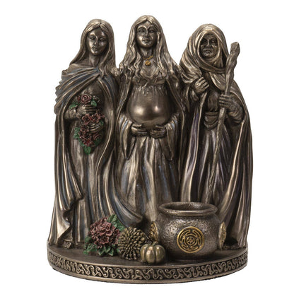 The Witches' Quest bronze-toned Triple Goddess figurine featuring Maiden, Mother, and Crone with a cauldron on a Celtic base.
