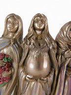 The Witches' Quest Triple Goddess statue featuring Maiden, Mother, and Crone figures in a bronze-toned resin finish.