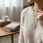 The Witches' Quest silver tone heart pendant necklace featuring a Triple Moon goddess relief on a delicate cable chain