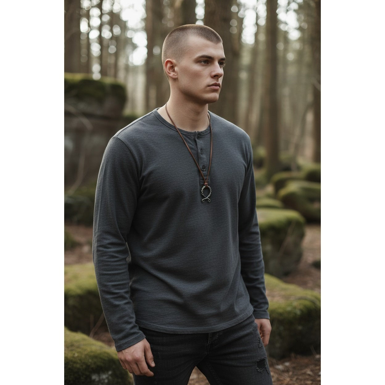 The Witches' Quest Norse Viking necklace with a twisted silver-tone pendant on a brown leather cord worn by a man.