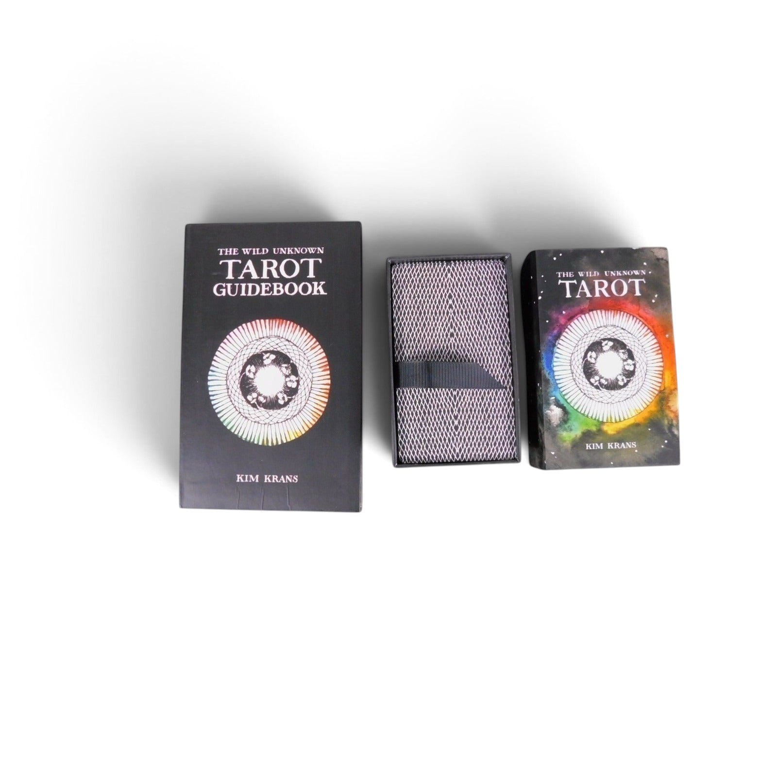 The Witches' Quest The Wild Unknown tarot deck and guidebook set featuring black boxes with rainbow mandala artwork.