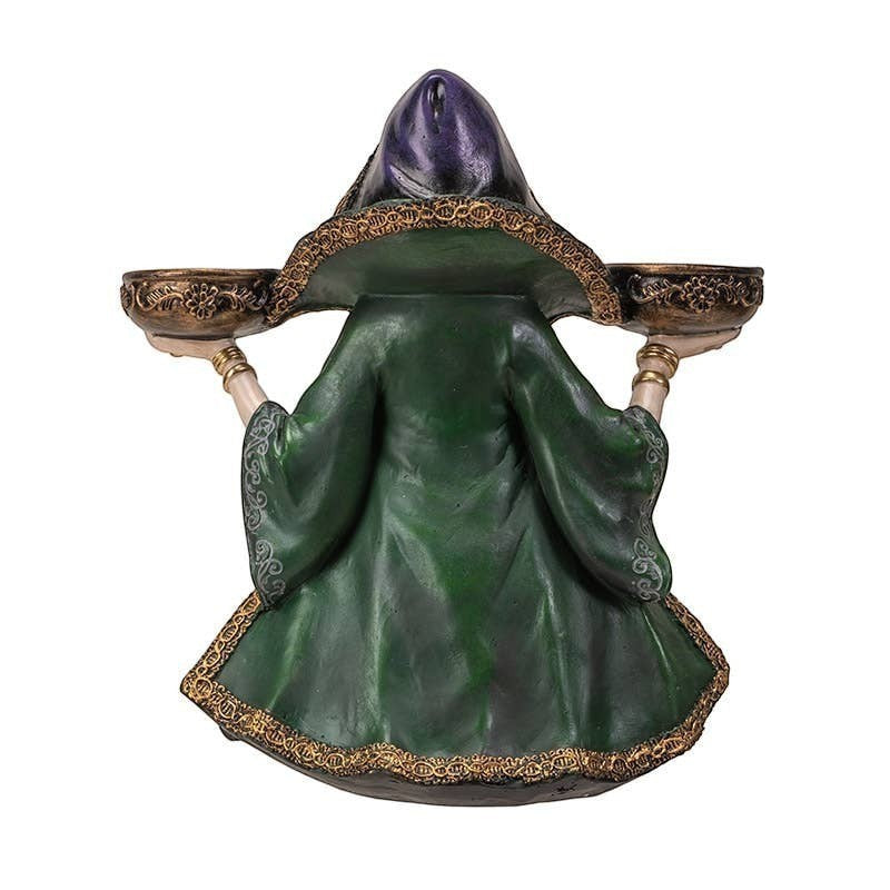 The Witches' Quest witch candle holder statue in a green and purple hooded gown holding two ornate tea light bowls