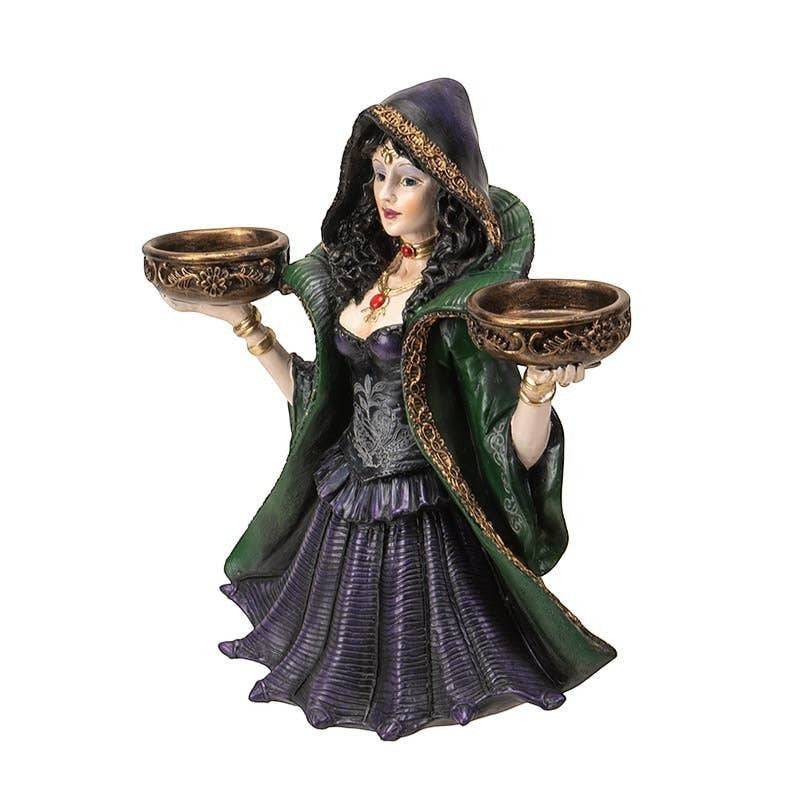 The Witches' Quest enchanted witch statue candle holder in a green and purple gown holding two ornate tea light bowls.
