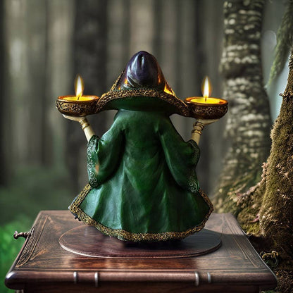 The Witches' Quest enchanted witch statue holding two tea light candles, wearing a green and purple hooded gown.