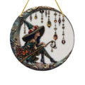 The Witches' Quest decorative wall hanging featuring a witch in a floral hat sitting on a crescent moon with jewels.