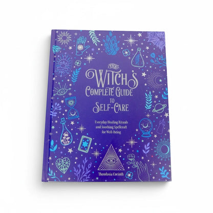 The Witches' Quest The Witch's Complete Guide to Self-Care hardcover book with purple cover and mystical illustrations.