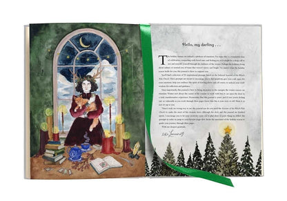 The Witches' Quest Seasons of the Witch Yule Journal open to an illustrated page with a green ribbon bookmark.