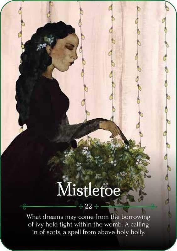 The Witches' Quest Seasons of the Witch Yule Oracle card featuring a woman holding mistletoe with festive string lights.
